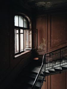 black and brown stairs beside window