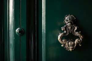 antique brass handle on green door